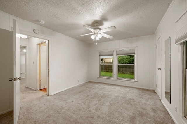 unfurnished bedroom with a ceiling fan, a textured ceiling, and carpet