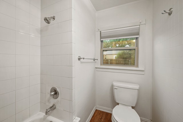 full bath featuring bathtub / shower combination, toilet, and wood finished floors