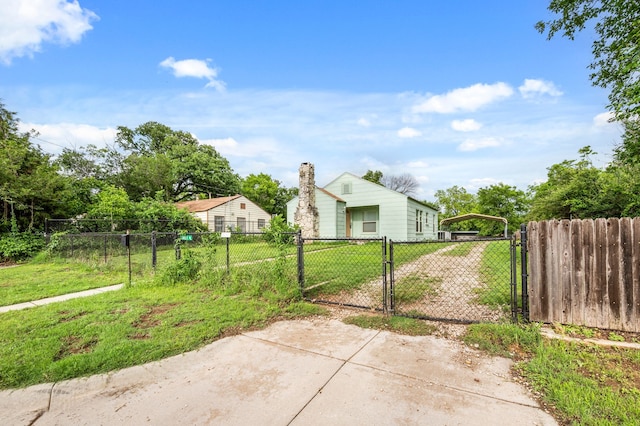 view of gate featuring fence and a yard