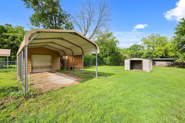 view of yard featuring a detached garage, fence, and an outdoor structure