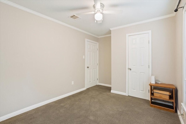 unfurnished bedroom with ceiling fan, visible vents, crown molding, carpet floors, and baseboards