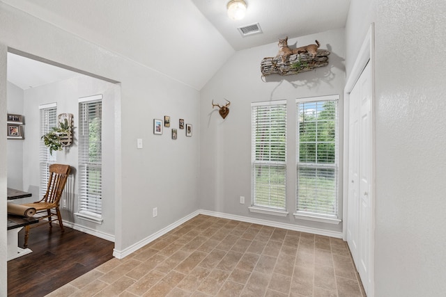 dining space featuring baseboards, vaulted ceiling, and visible vents