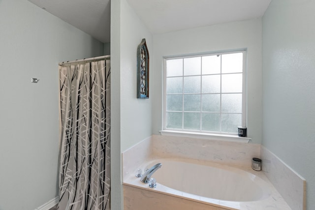 bathroom featuring a bath and curtained shower