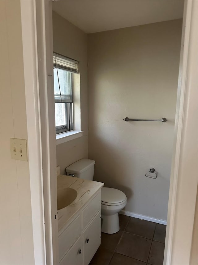 202 S Spencer St, Mart, TX 76664 - half bath with tile patterned floors, baseboards, vanity, and toilet