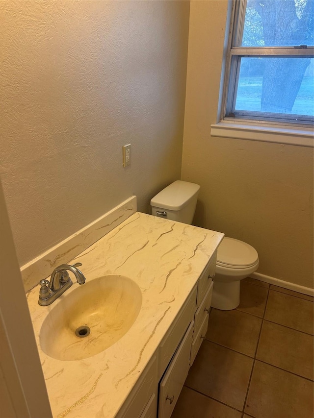 202 S Spencer St, Mart, TX 76664 - half bath with toilet, baseboards, tile patterned flooring, and vanity