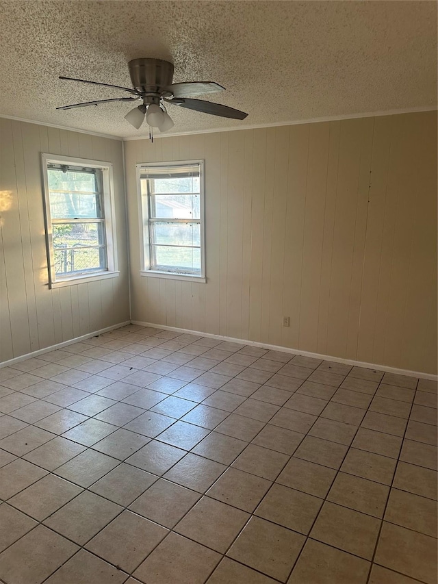 202 S Spencer St, Mart, TX 76664 - unfurnished room with light tile patterned floors, baseboards, a ceiling fan, and a textured ceiling