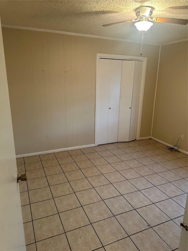 202 S Spencer St, Mart, TX 76664 - unfurnished bedroom with a closet, ornamental molding, a textured ceiling, and ceiling fan
