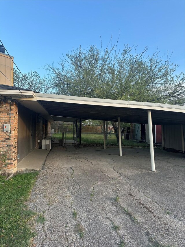 202 S Spencer St, Mart, TX 76664 - view of parking / parking lot with aphalt driveway and an attached carport