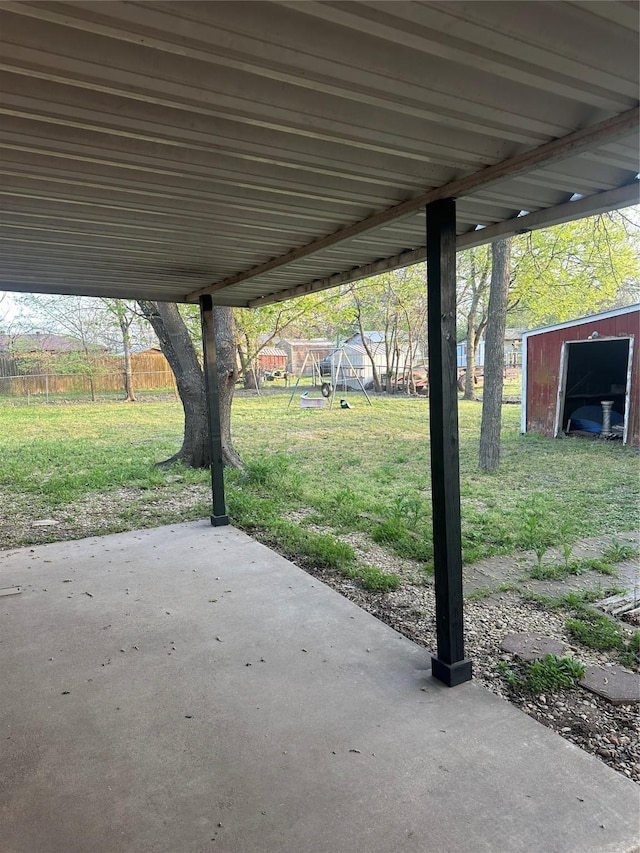 202 S Spencer St, Mart, TX 76664 - view of patio with fence, a shed, an outdoor structure, and a carport