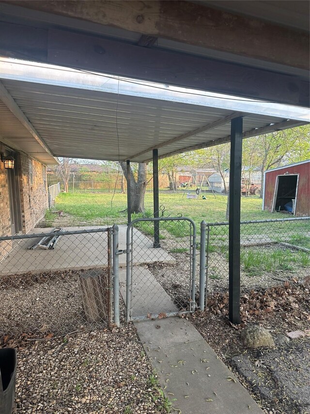 202 S Spencer St, Mart, TX 76664 - exterior space with a gate, a playground, fence, and a carport