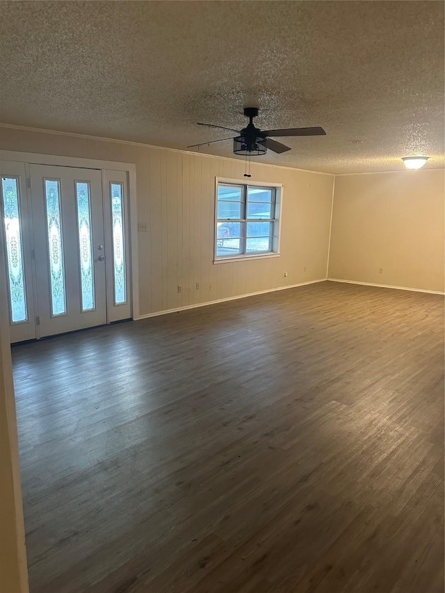 202 S Spencer St, Mart, TX 76664 - spare room with a ceiling fan, a textured ceiling, and dark wood-type flooring
