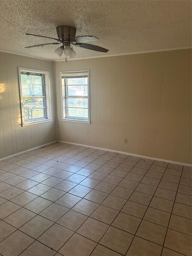 202 S Spencer St, Mart, TX 76664 - empty room featuring baseboards, a textured ceiling, ceiling fan, and light tile patterned flooring