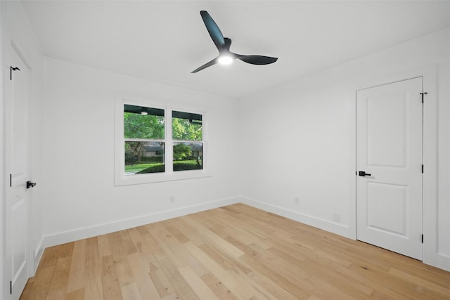 unfurnished room featuring ceiling fan, baseboards, and light wood finished floors