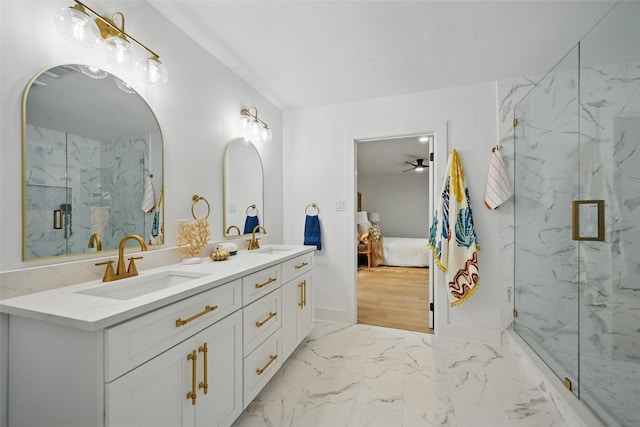 full bathroom with a sink, a marble finish shower, ensuite bathroom, and double vanity