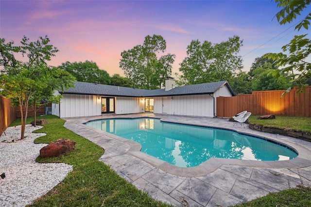 view of pool featuring french doors, a fenced backyard, a fenced in pool, a patio area, and a lawn