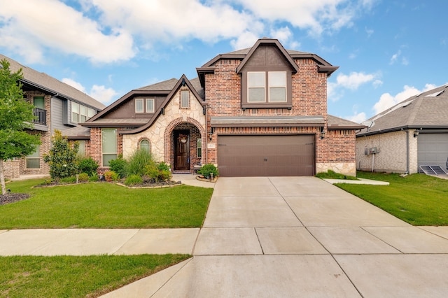1617 Mack Ln, Little Elm, TX 75068 - view of front of property featuring stone siding, brick siding, a garage, concrete driveway, and a front yard