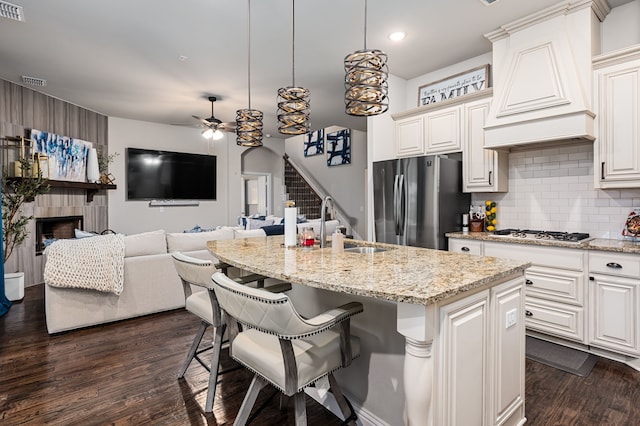 1617 Mack Ln, Little Elm, TX 75068 - kitchen with stainless steel appliances, custom range hood, a sink, dark wood-type flooring, and ceiling fan