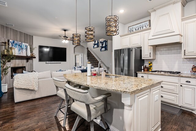 1617 Mack Ln, Little Elm, TX 75068 - kitchen with stainless steel appliances, custom range hood, a sink, dark wood-type flooring, and ceiling fan