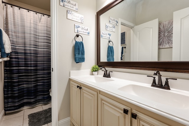 1617 Mack Ln, Little Elm, TX 75068 - bathroom with tile patterned flooring, double vanity, and baseboards