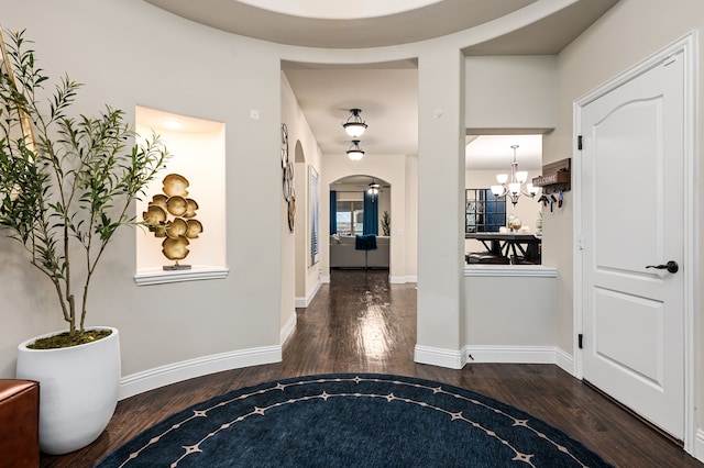 1617 Mack Ln, Little Elm, TX 75068 - corridor featuring wood finished floors, arched walkways, a chandelier, and baseboards
