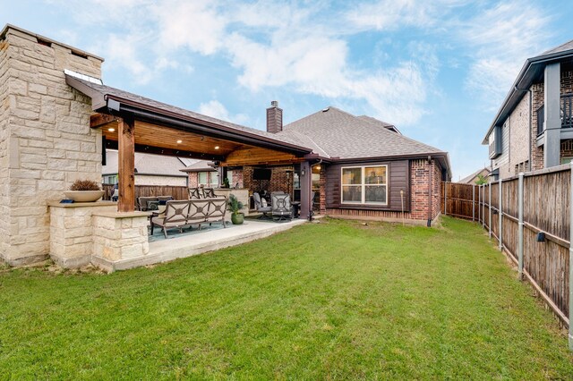1617 Mack Ln, Little Elm, TX 75068 - back of property featuring a chimney, a patio area, brick siding, and a shingled roof