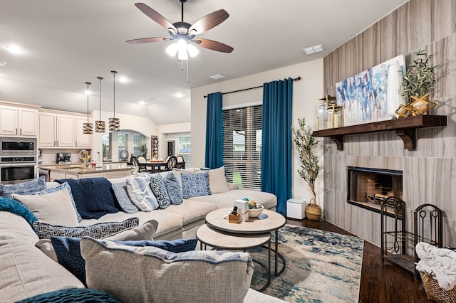 1617 Mack Ln, Little Elm, TX 75068 - living area with dark wood-style floors, a ceiling fan, a large fireplace, and vaulted ceiling
