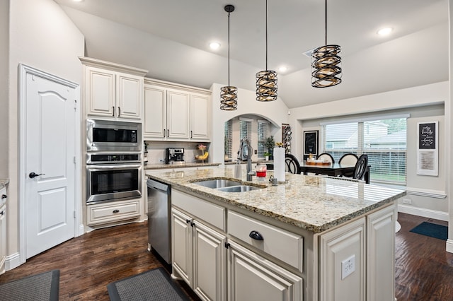 1617 Mack Ln, Little Elm, TX 75068 - kitchen with appliances with stainless steel finishes, a sink, vaulted ceiling, dark wood finished floors, and light stone countertops