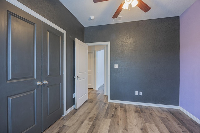 2801 17th St, Fort Worth, TX 76106 - unfurnished bedroom with ceiling fan, baseboards, wood finished floors, visible vents, and a closet