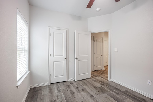 2801 17th St, Fort Worth, TX 76106 - unfurnished bedroom with wood finished floors and multiple windows