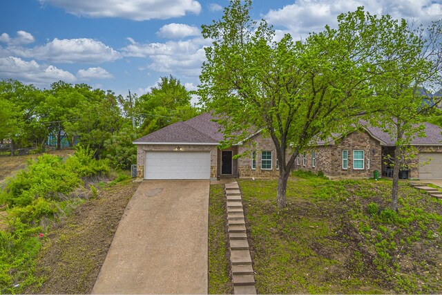 2801 17th St, Fort Worth, TX 76106 - view of front facade with an attached garage, driveway, and brick siding