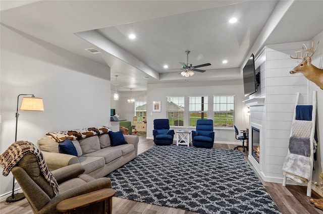 141 Walnut St, Paradise, TX 76073 - living room featuring ceiling fan, wood finished floors, a raised ceiling, baseboards, and recessed lighting