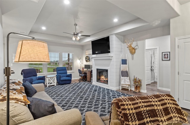 141 Walnut St, Paradise, TX 76073 - living room featuring baseboards, a raised ceiling, a ceiling fan, wood finished floors, and a large fireplace