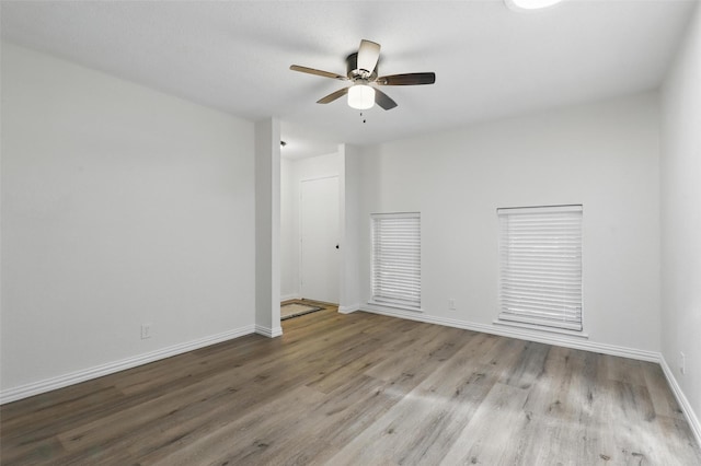 1038 Oak Hurst Dr, Grapevine, TX 76051 - spare room featuring wood finished floors, ceiling fan, and baseboards