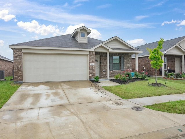view of front of home with a garage, a front lawn, central AC, brick siding, and driveway