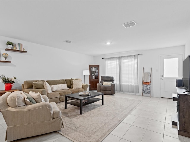 living area with light tile patterned flooring and visible vents