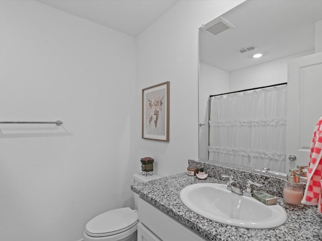 bathroom featuring visible vents, a shower with curtain, toilet, and vanity