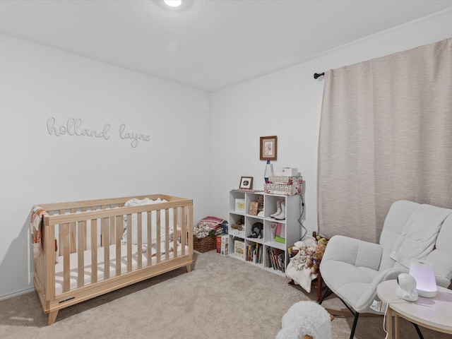 carpeted bedroom with a crib