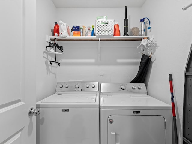 clothes washing area with separate washer and dryer and laundry area