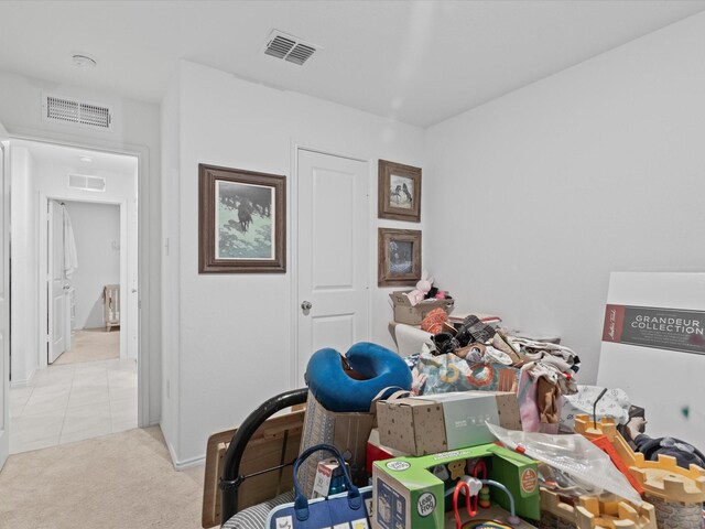 carpeted office space featuring tile patterned floors, baseboards, and visible vents