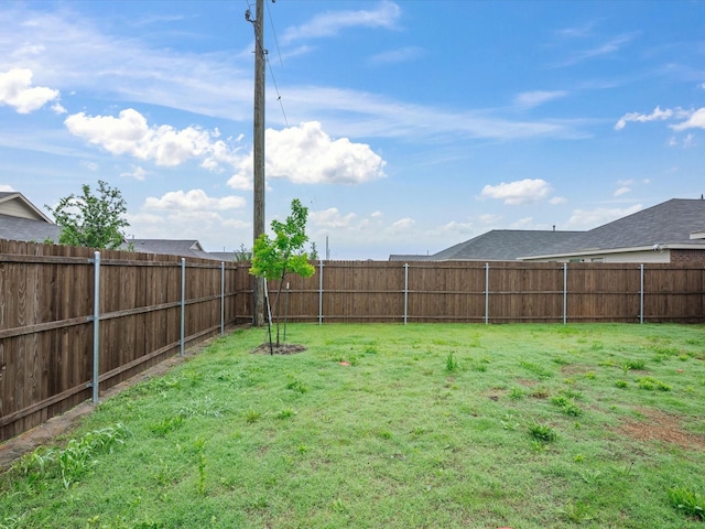 view of yard with a fenced backyard