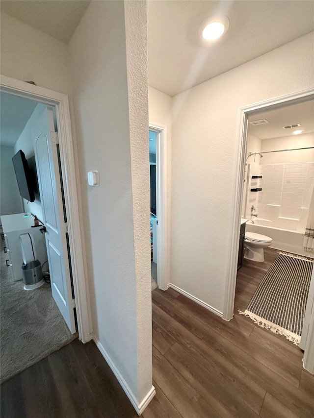 corridor with baseboards and dark wood finished floors