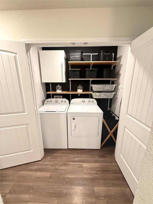 washroom with wood finished floors and washer and clothes dryer