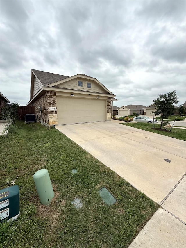 view of front of house featuring a garage, concrete driveway, a front lawn, and brick siding