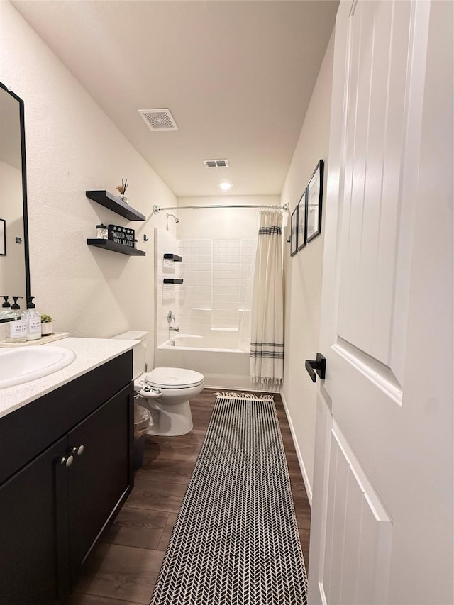 full bath with visible vents, wood finished floors, toilet, and vanity