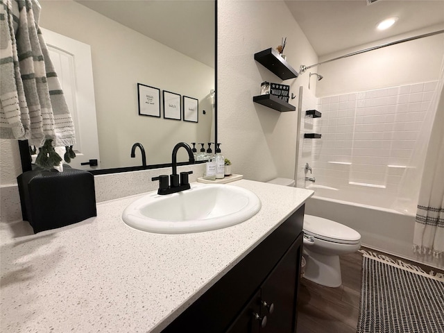 full bath featuring vanity, toilet, wood finished floors, and shower / tub combo