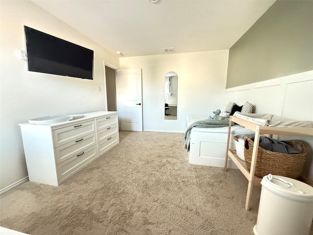 bedroom with baseboards, light carpet, and visible vents