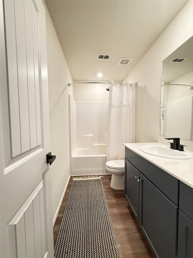 bathroom with vanity, toilet, shower / bathtub combination with curtain, wood finished floors, and visible vents