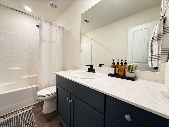 bathroom featuring vanity, toilet, wood finished floors, and visible vents