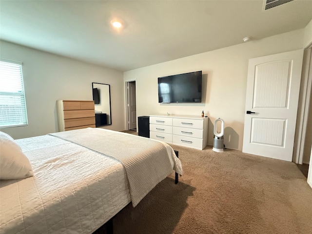 bedroom featuring carpet flooring and visible vents