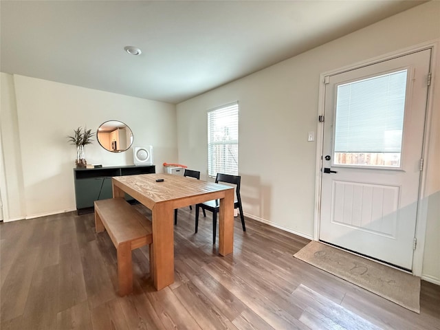 dining space featuring baseboards and dark wood-style floors